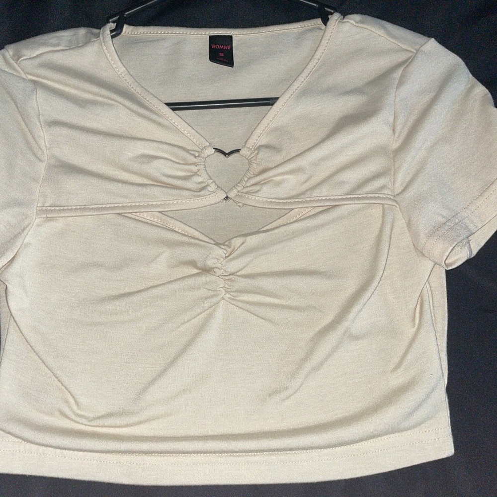 Cream colored crop top with heart in center of chest